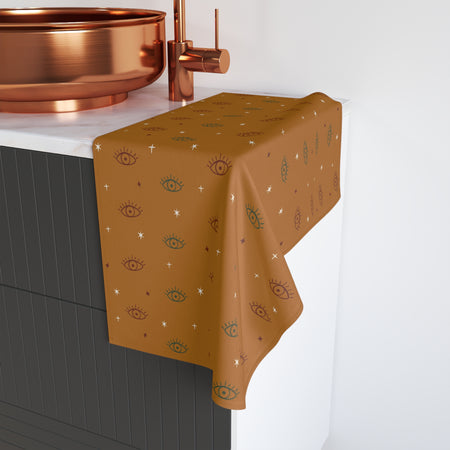 Gold decorative towel with eye pattern on a kitchen counter