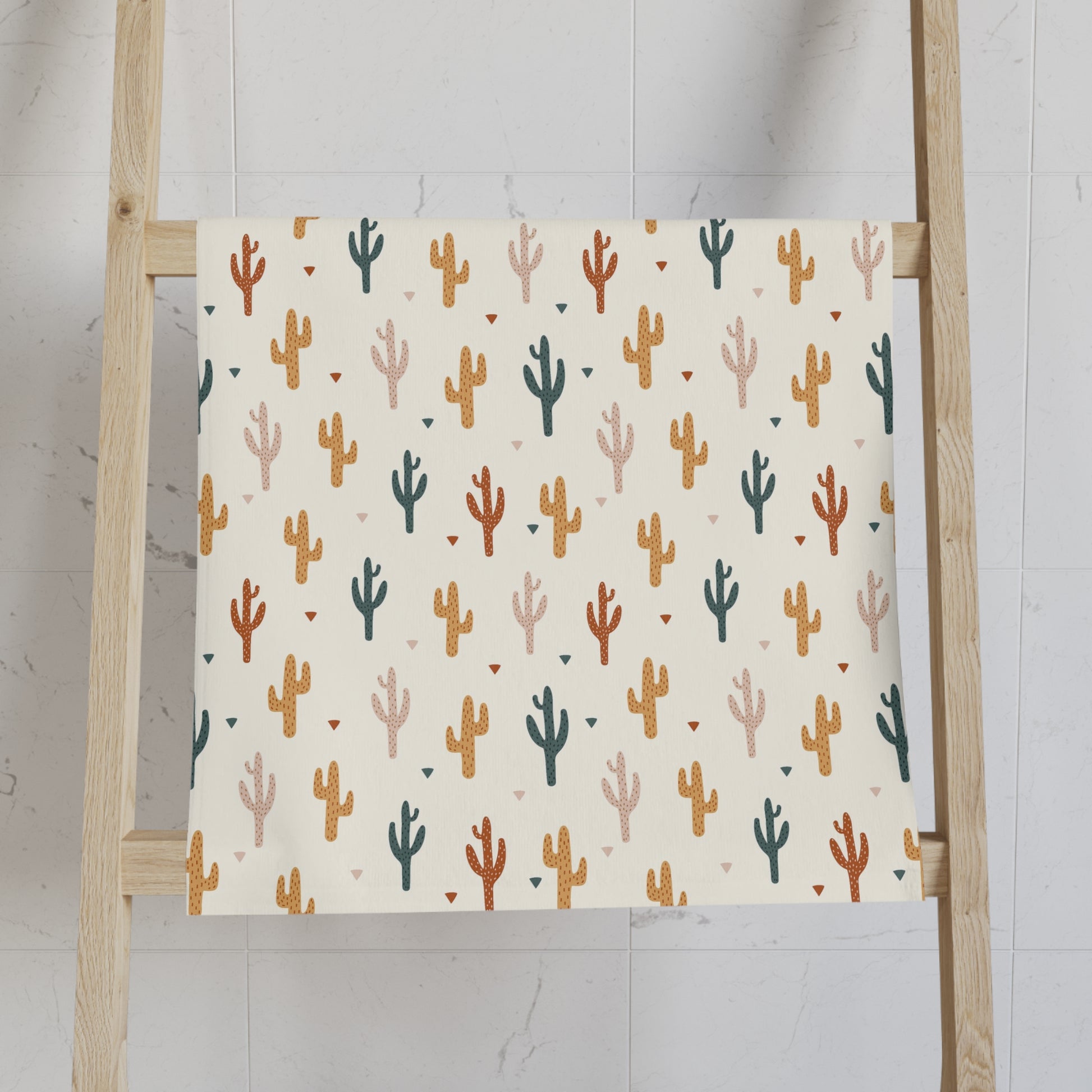 Patterned towel on a wooden ladder against a light background