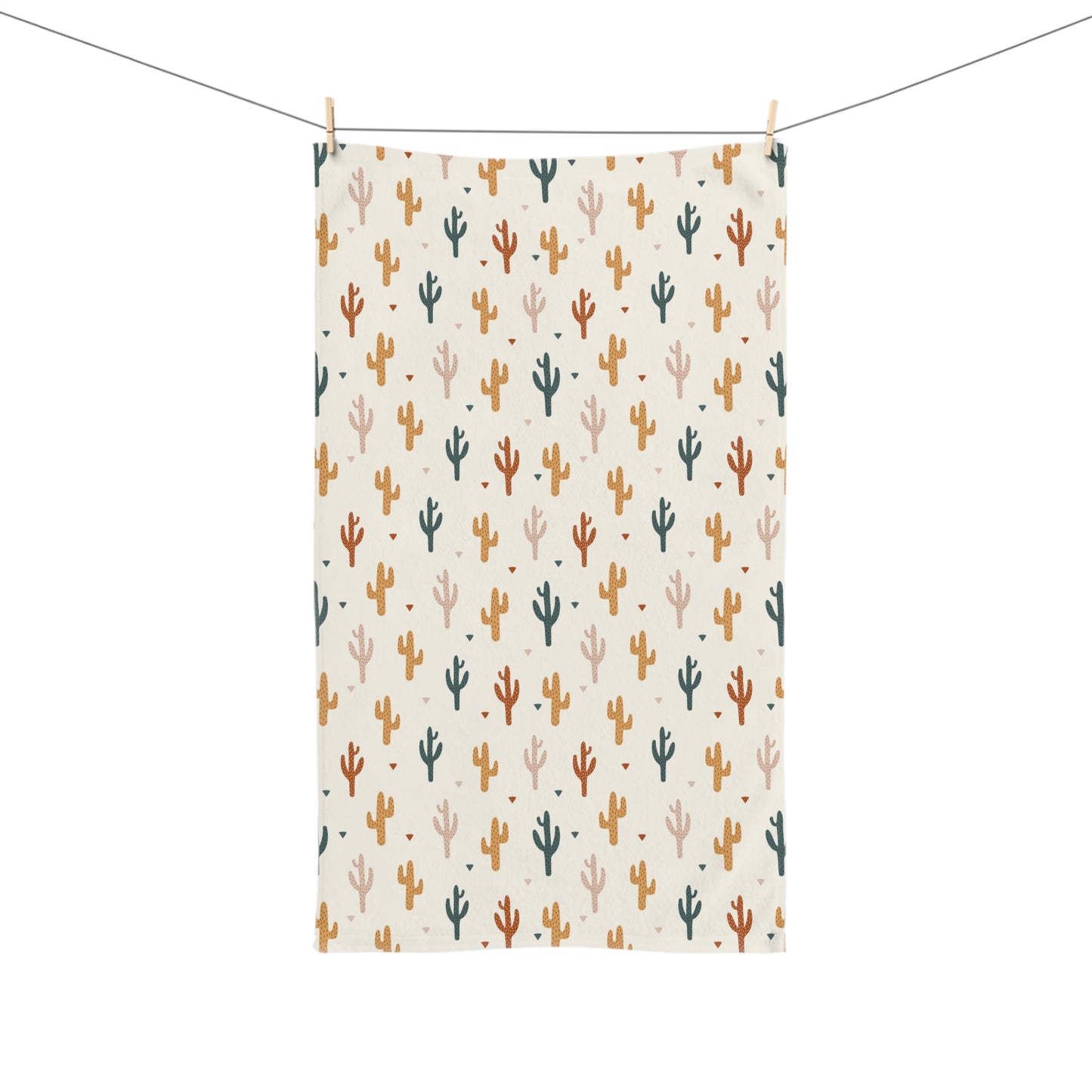 Decorative towel with cactus pattern hanging on a line