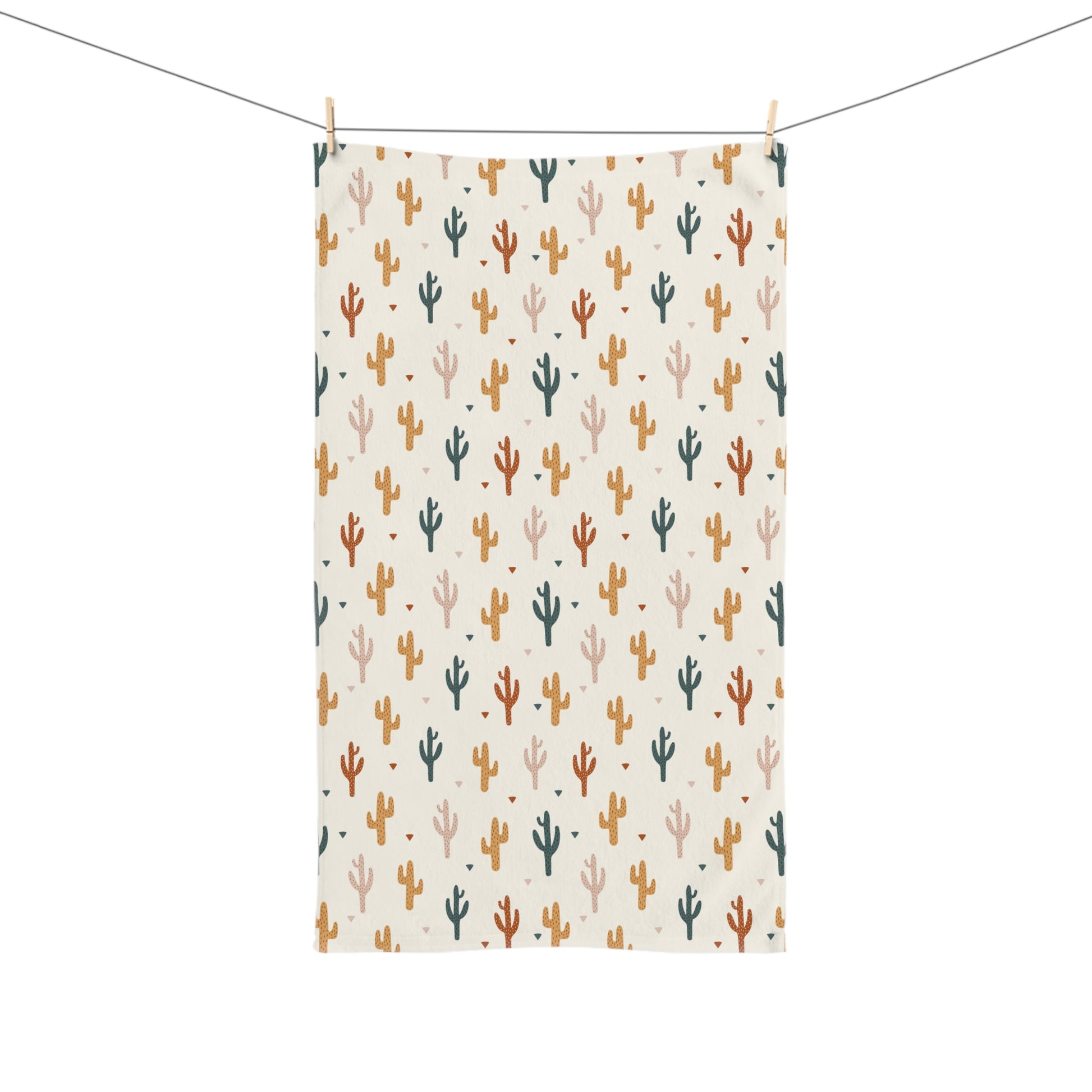 Decorative towel with cactus pattern hanging on a line