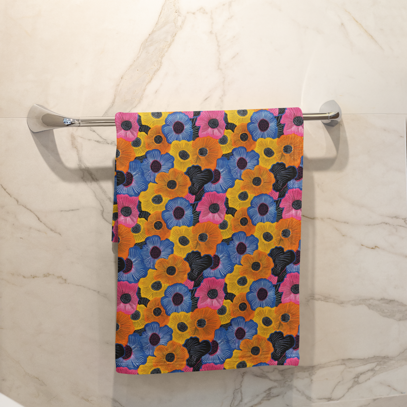 Colorful floral-patterned towel hanging on a rack against a marble wall.
