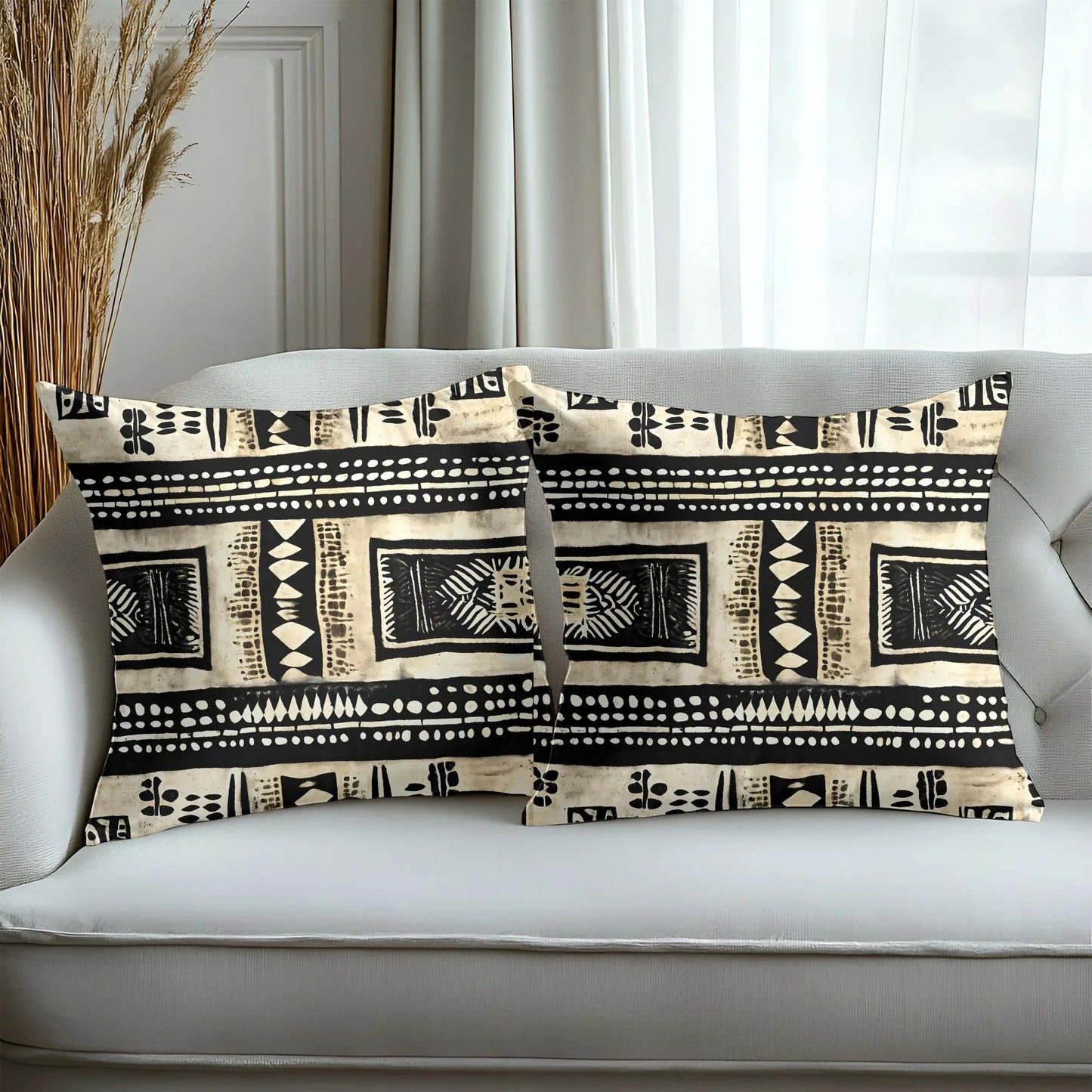 Boho tribal print throw pillows on a light sofa in a modern living room setting
