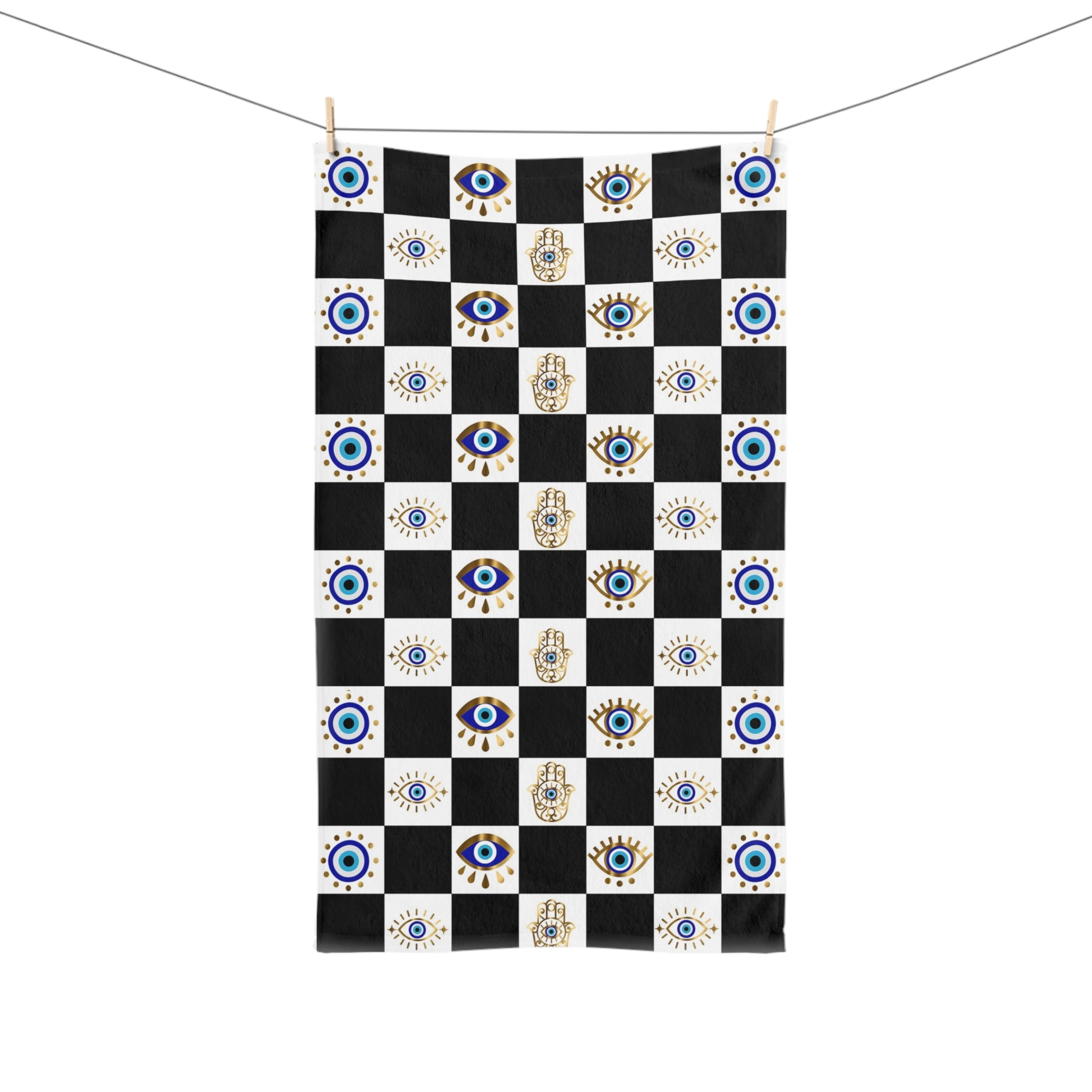Checkered towel with eye and hand designs on a white background