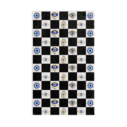 Checkered hand towel with eye and hand of god patterns on a black and white background