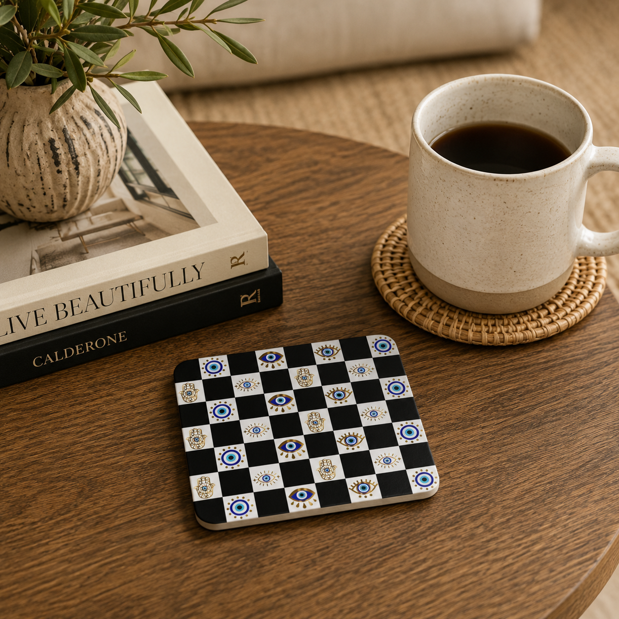 Checkered coaster on a wooden table with a cup of coffee and a book.