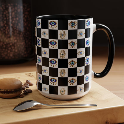 Checkered mug with eye pattern on a wooden surface with coffee beans and a macaron.