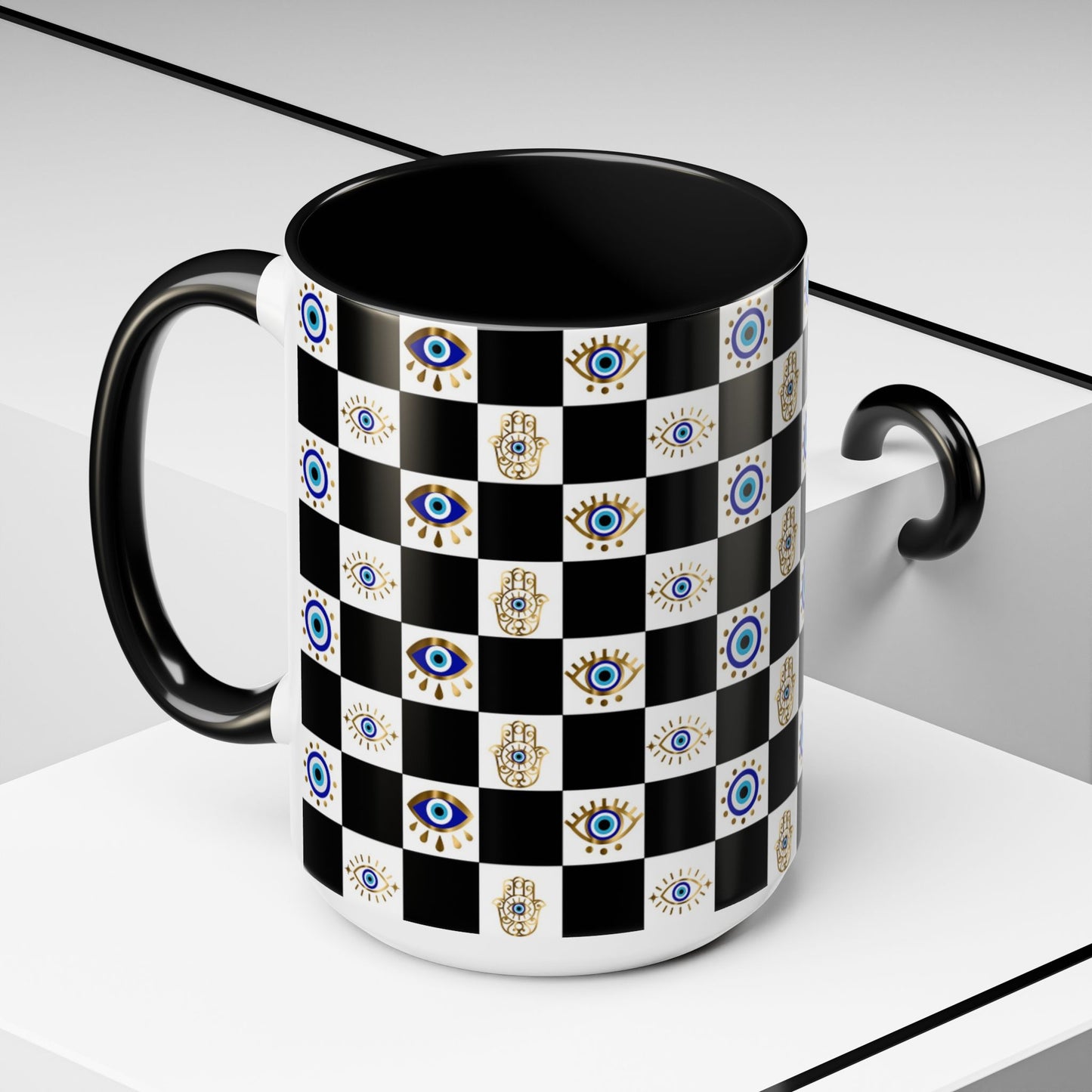 Black mug with a checkered pattern featuring evil eye and hamsa hands on a white background