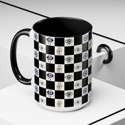 Black mug with a checkered pattern featuring evil eye and hamsa hands on a white background