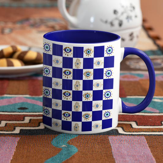 Blue and white checkered mug with a purple handle on a patterned tablecloth.