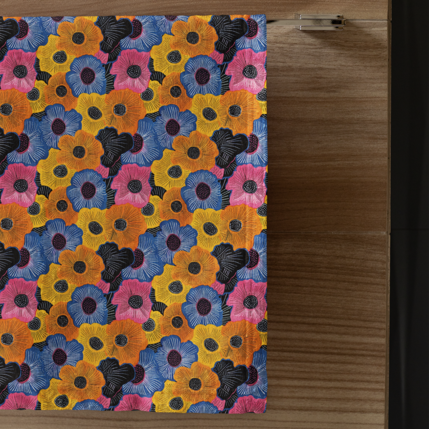 Colorful floral patterned hand towel on a wooden surface