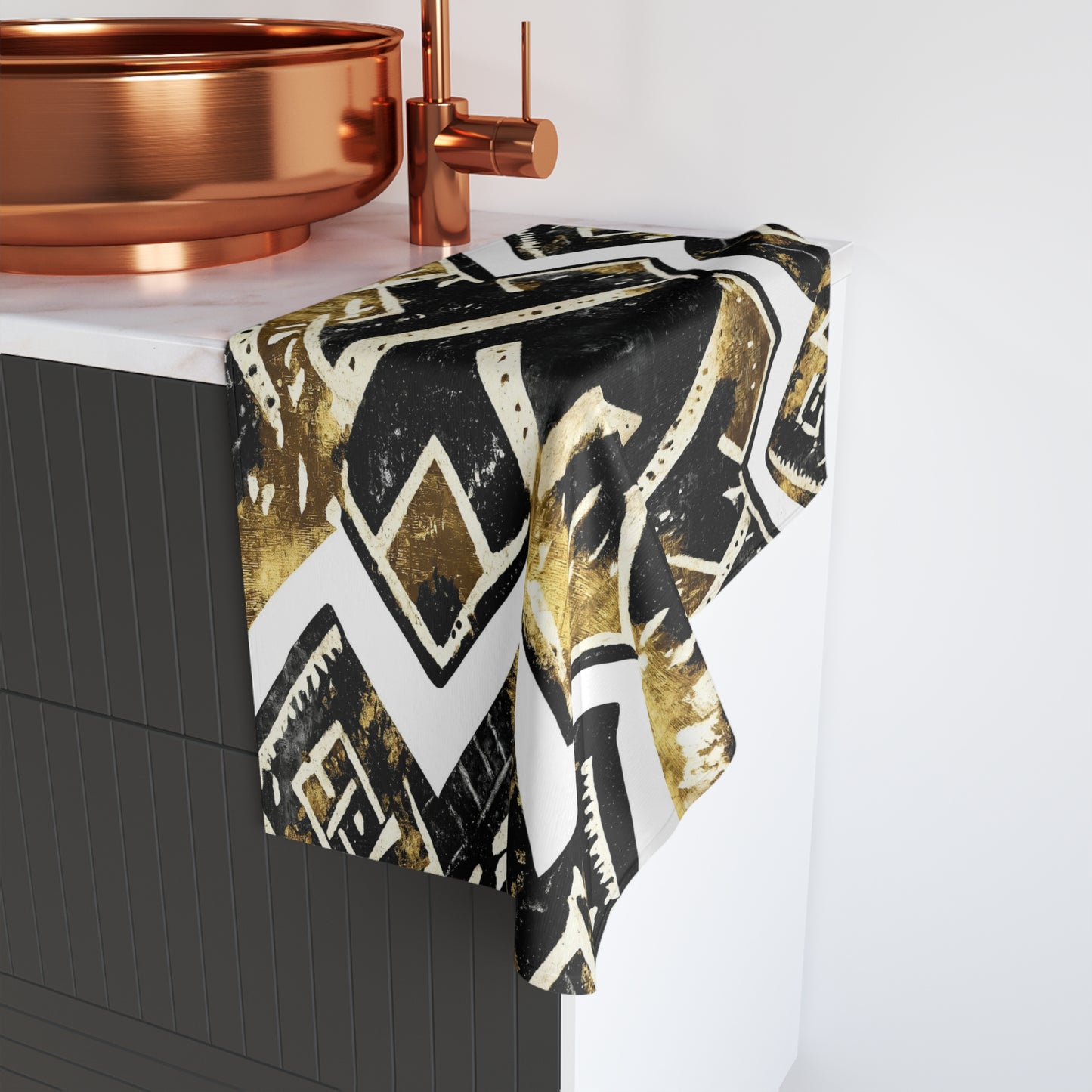 Patterned towel draped over a bathtub with copper fixtures.