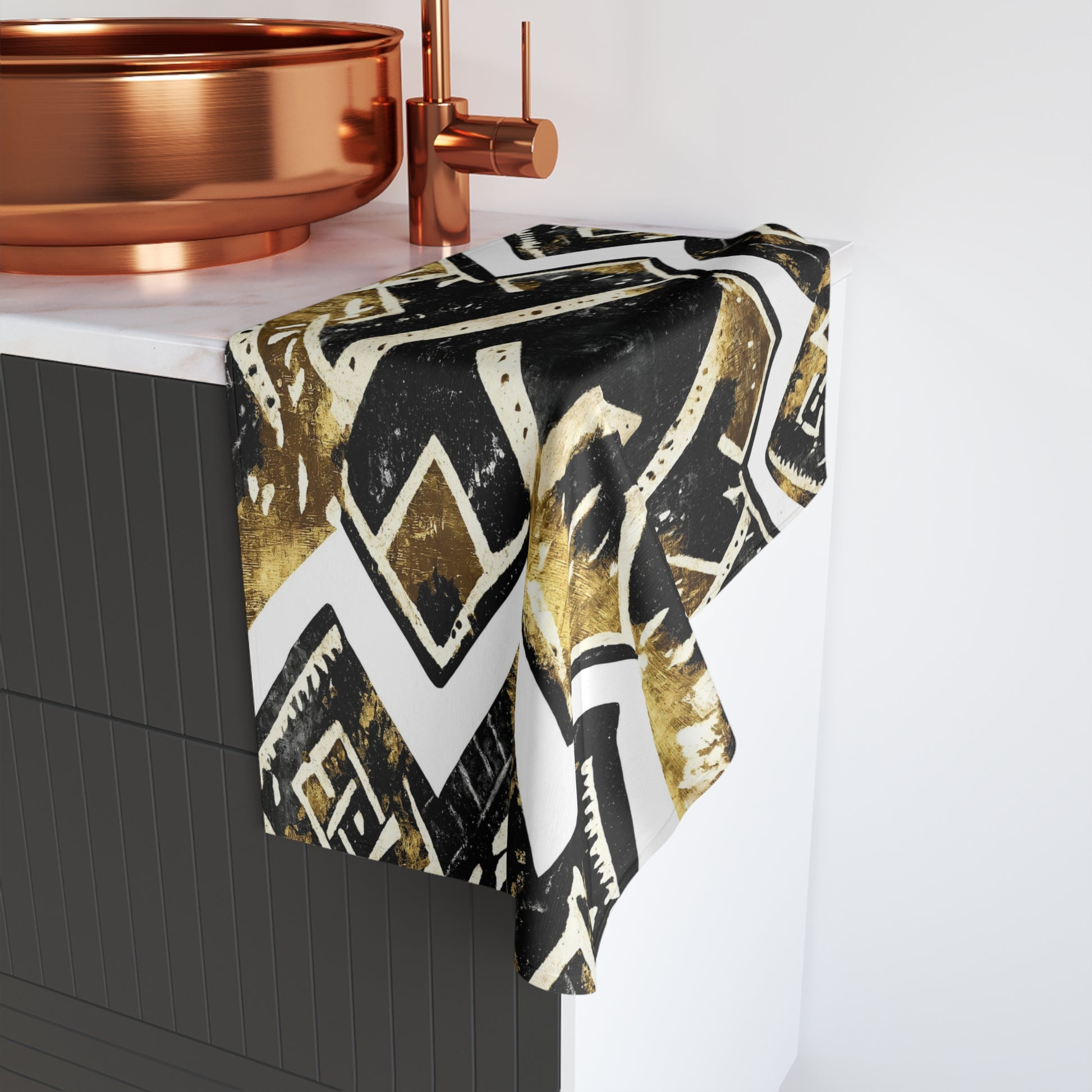 Patterned towel draped over a bathtub with copper fixtures.