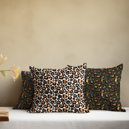 Three leopard print pillows on a white surface with a beige wall background