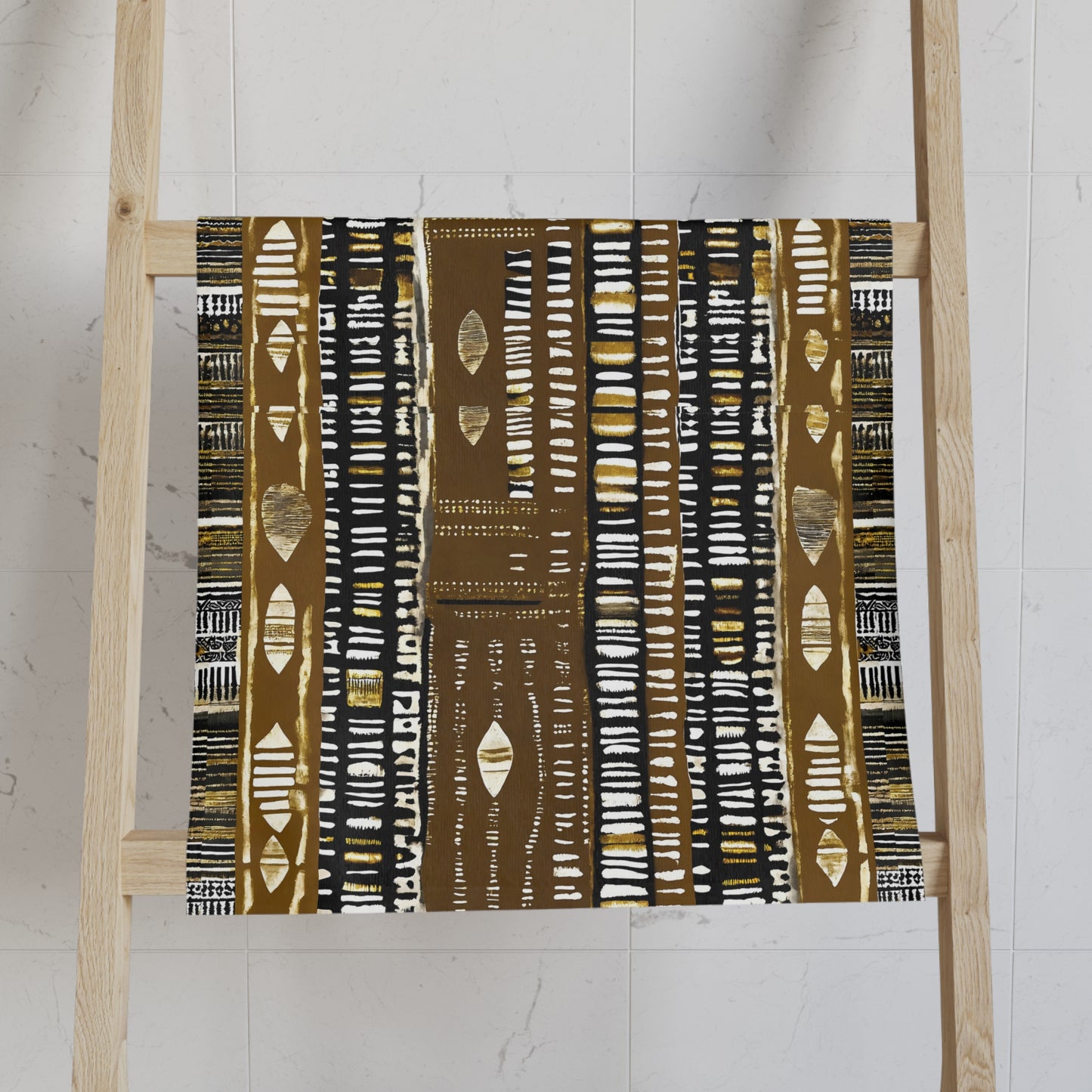 Mudcloth Print Fabric with a brown and white pattern on a wooden ladder against a white wall.