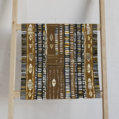 Mudcloth Print Fabric with a brown and white pattern on a wooden ladder against a white wall.