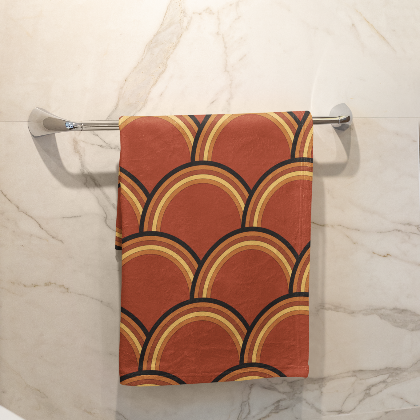 Towel with geometric pattern hanging on a rack in a bathroom setting