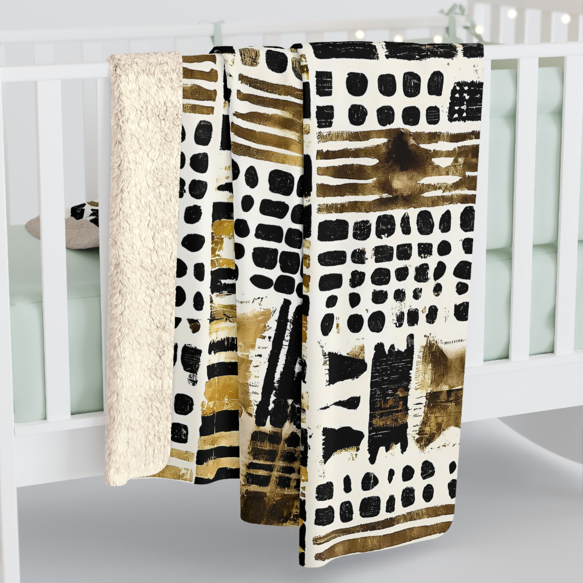 Three patterned blankets draped over a crib with a white background