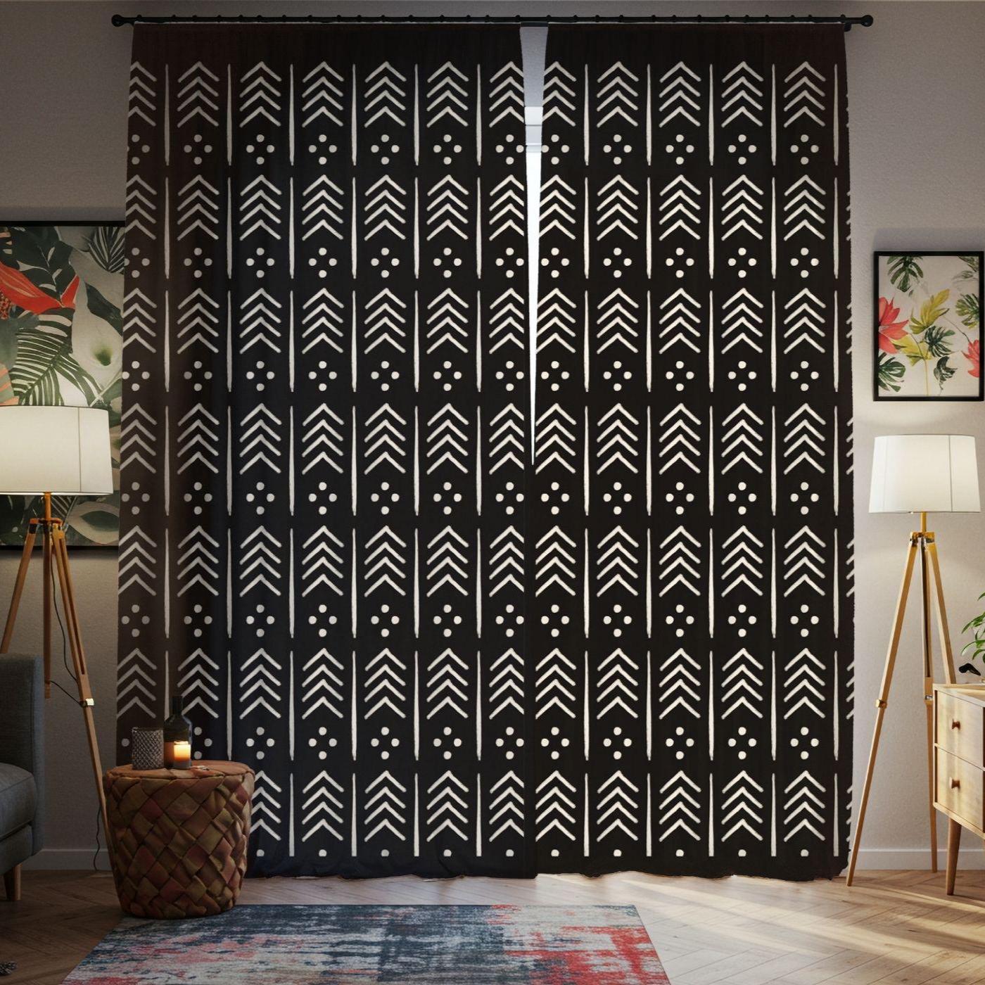 Black curtain with white geometric pattern in a room with decor elements.