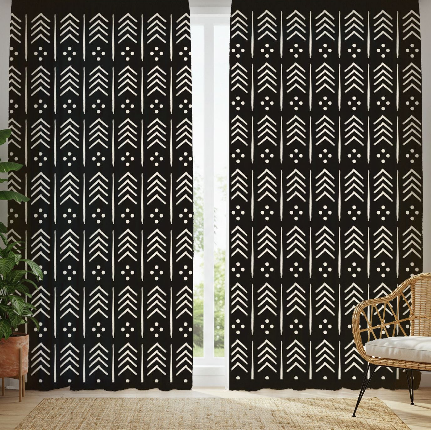 Black curtains with white geometric pattern in a room with plants and a chair.