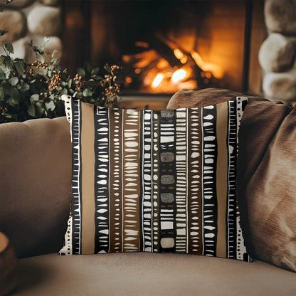 Mud cloth pattern throw pillow on sofa in cozy room with fireplace