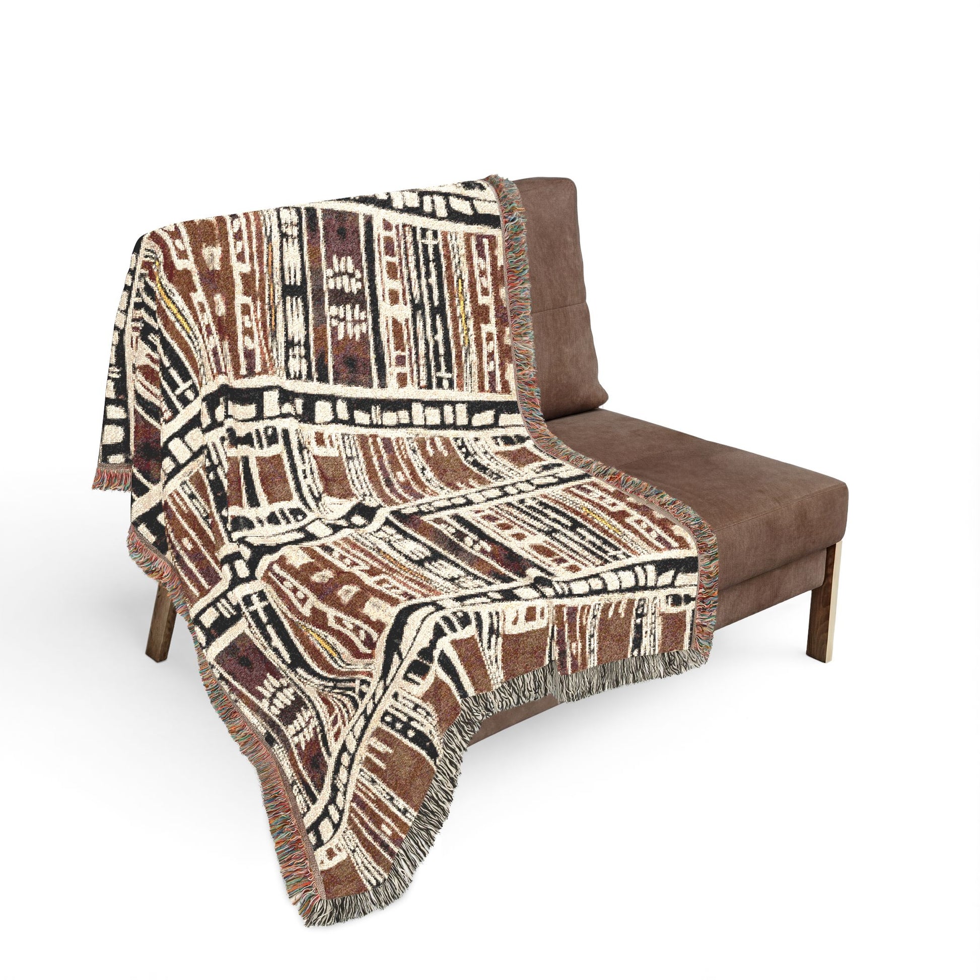 Patterned blanket draped over a brown chair on a white background