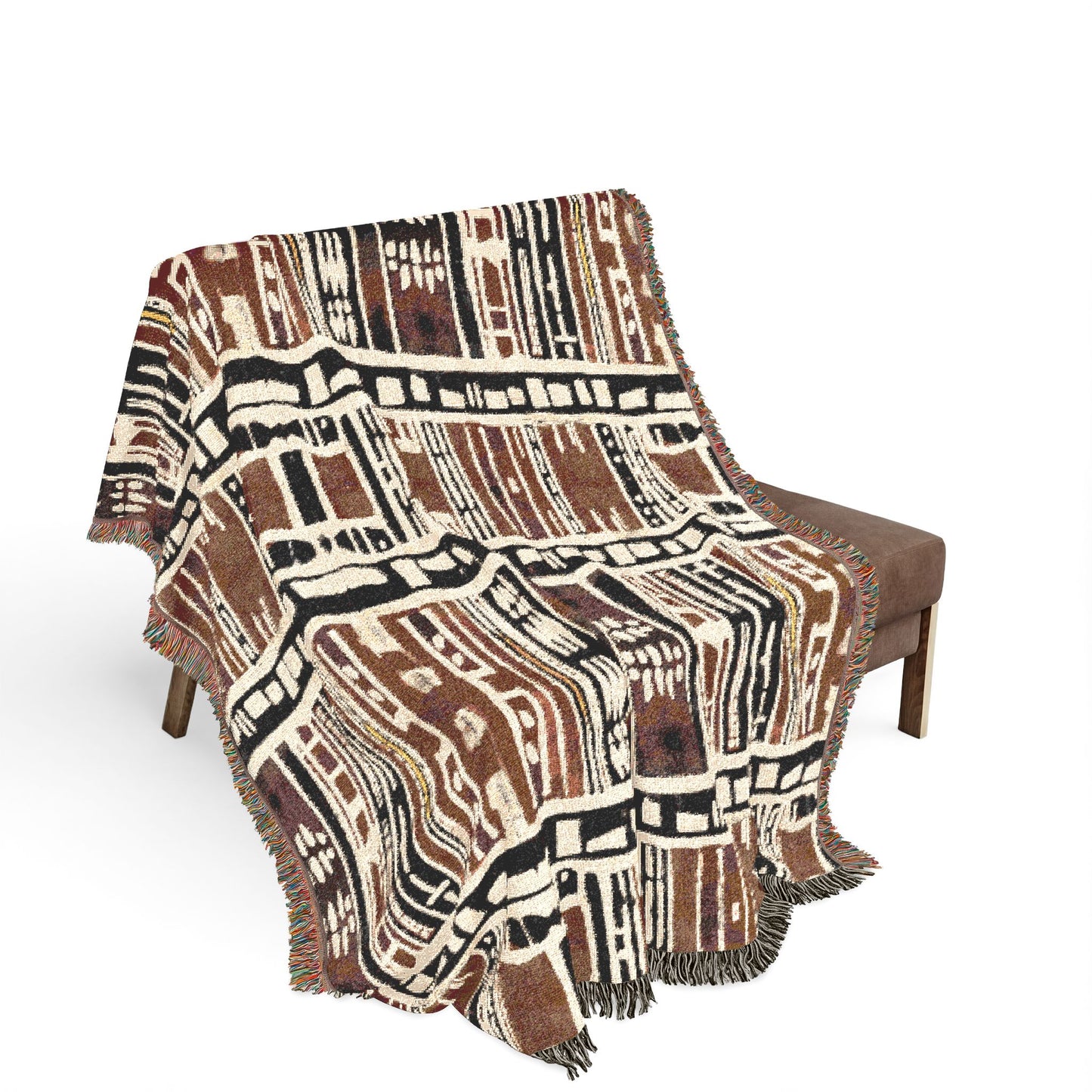 African Patterned blanket draped over a chair on a white background