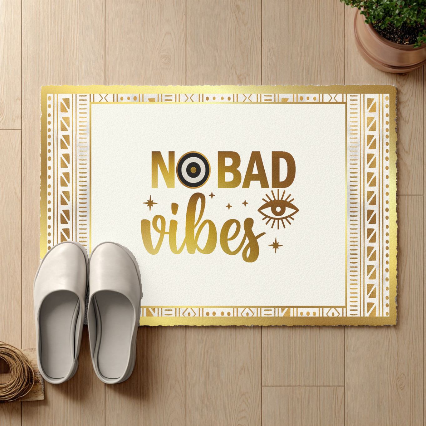Doormat with 'No Bad Vibes' text on a wooden floor with white shoes and a plant.