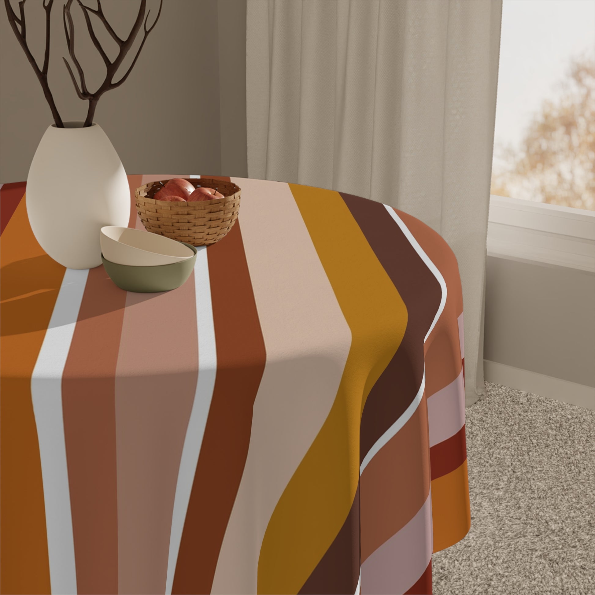 Tablecloth with autumnal stripe pattern on a table, with decorative items including a vase and bowl.
