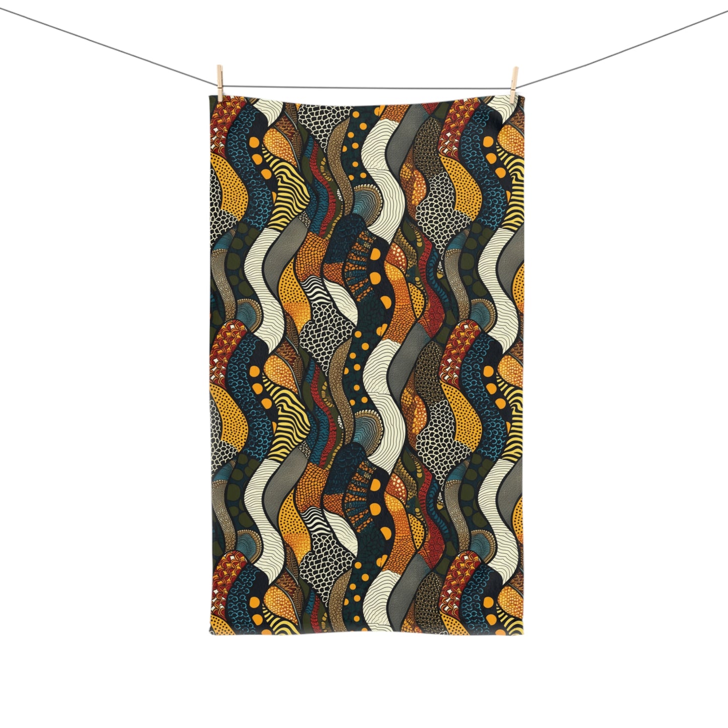 Colorful snakeskin patterned towel hanging on a line against a white background