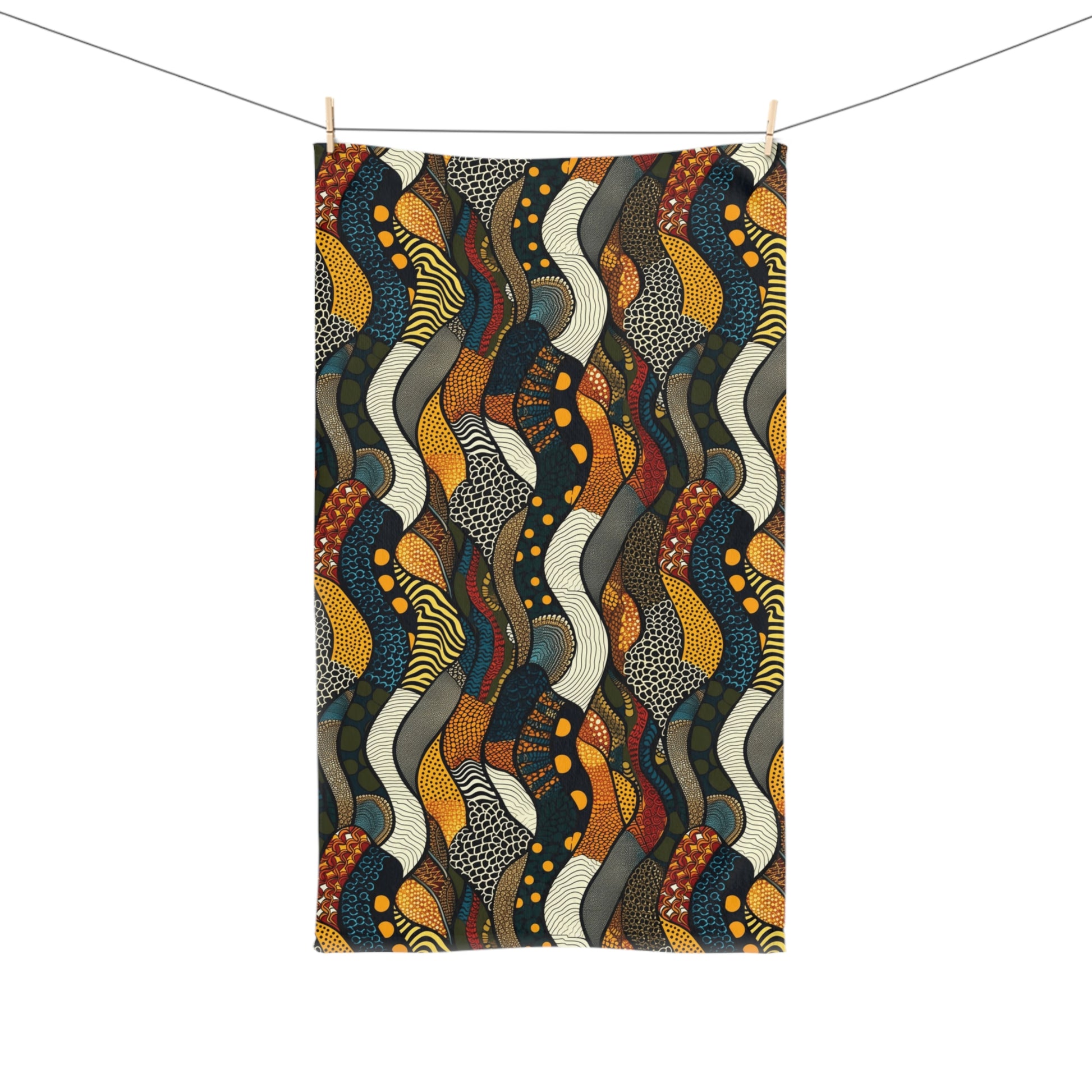 Colorful snakeskin patterned towel hanging on a line against a white background