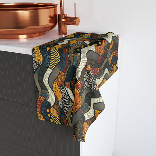 Colorful patterned towel draped over a bathroom faucet with copper fixtures.