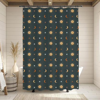 A dark teal shower curtain with a repeating celestial pattern of yellow suns, white crescent moons, and orange stars, hanging in a bright, modern bathroom with white wood paneling and a window.