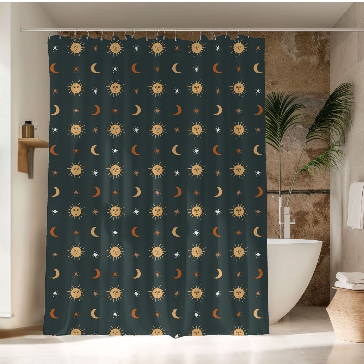 A dark teal shower curtain with a repeating pattern of smiling suns, crescent moons, and small stars, hanging in a bathroom next to a white bathtub and a potted plant.