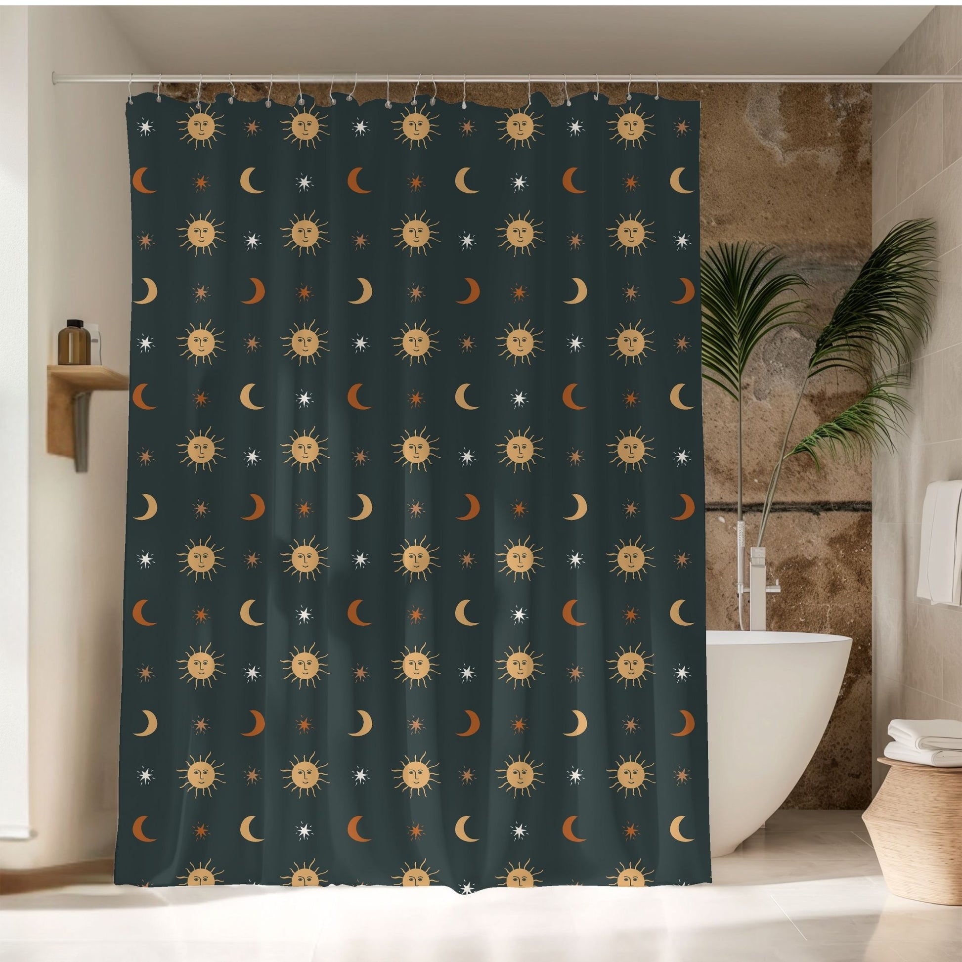 A dark teal shower curtain with a repeating pattern of smiling suns, crescent moons, and small stars, hanging in a bathroom next to a white bathtub and a potted plant.