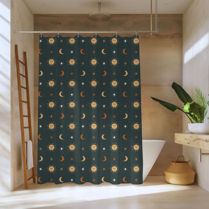 A dark teal shower curtain with a repeating pattern of yellow suns, crescent moons, and small stars, hanging in a modern bathroom with a wooden ladder shelf, white bathtub, and potted plant.