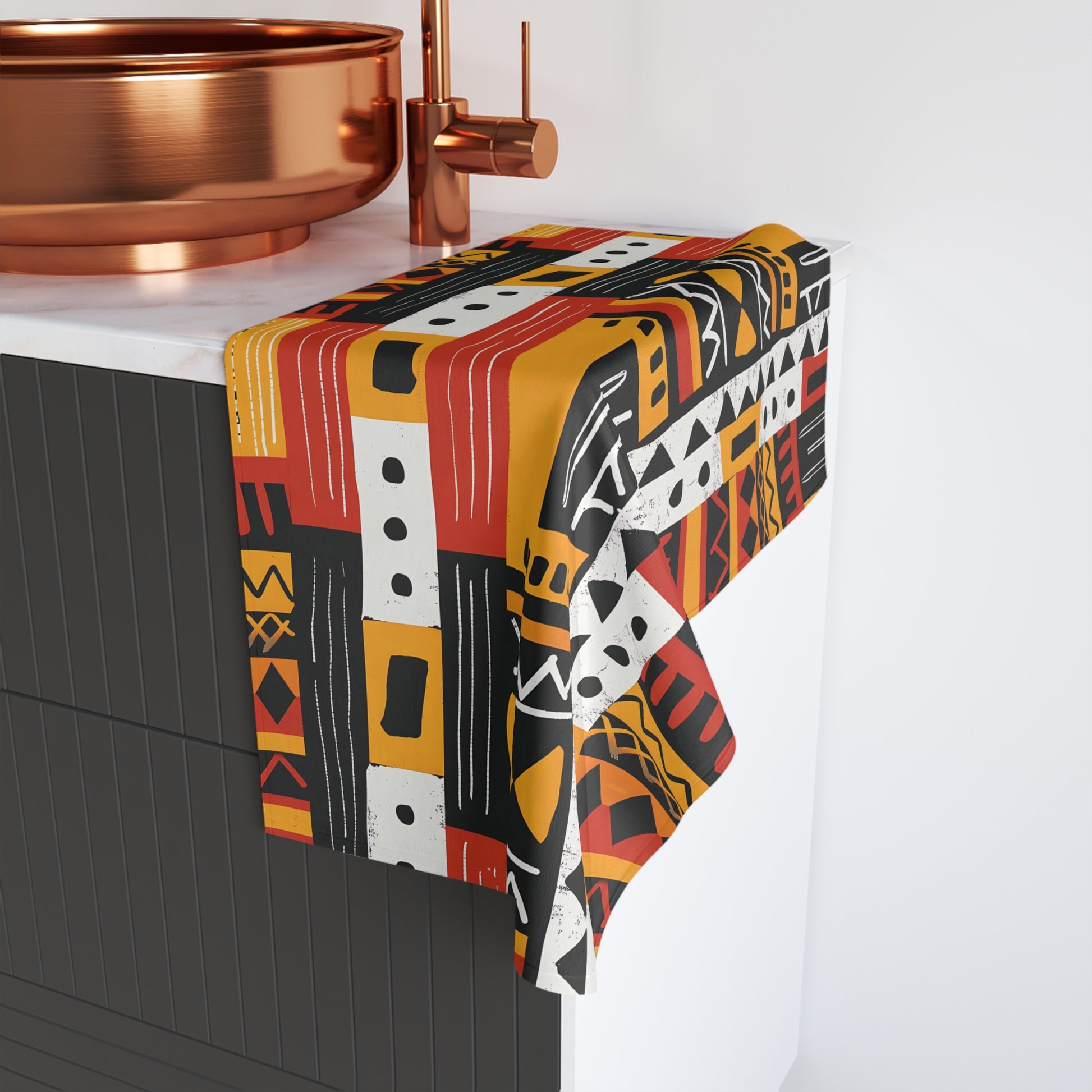 Patterned towel draped over a bathroom fixture with copper elements.