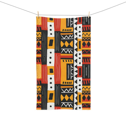 Colorful patterned towel hanging on a line against a white background