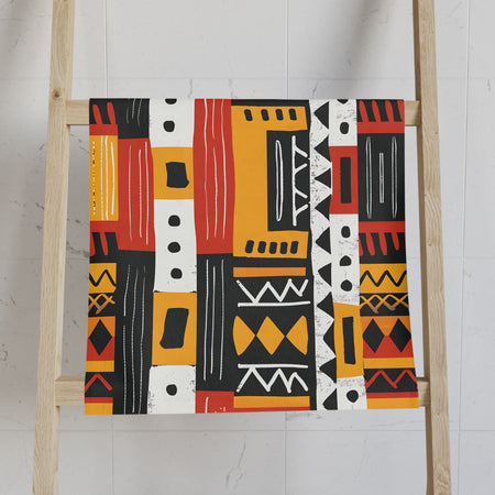 Patterned towel on a wooden ladder against a white wall