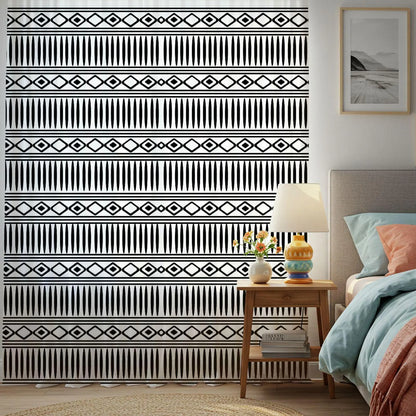 Bedroom with a patterned wall, nightstand, and bed.