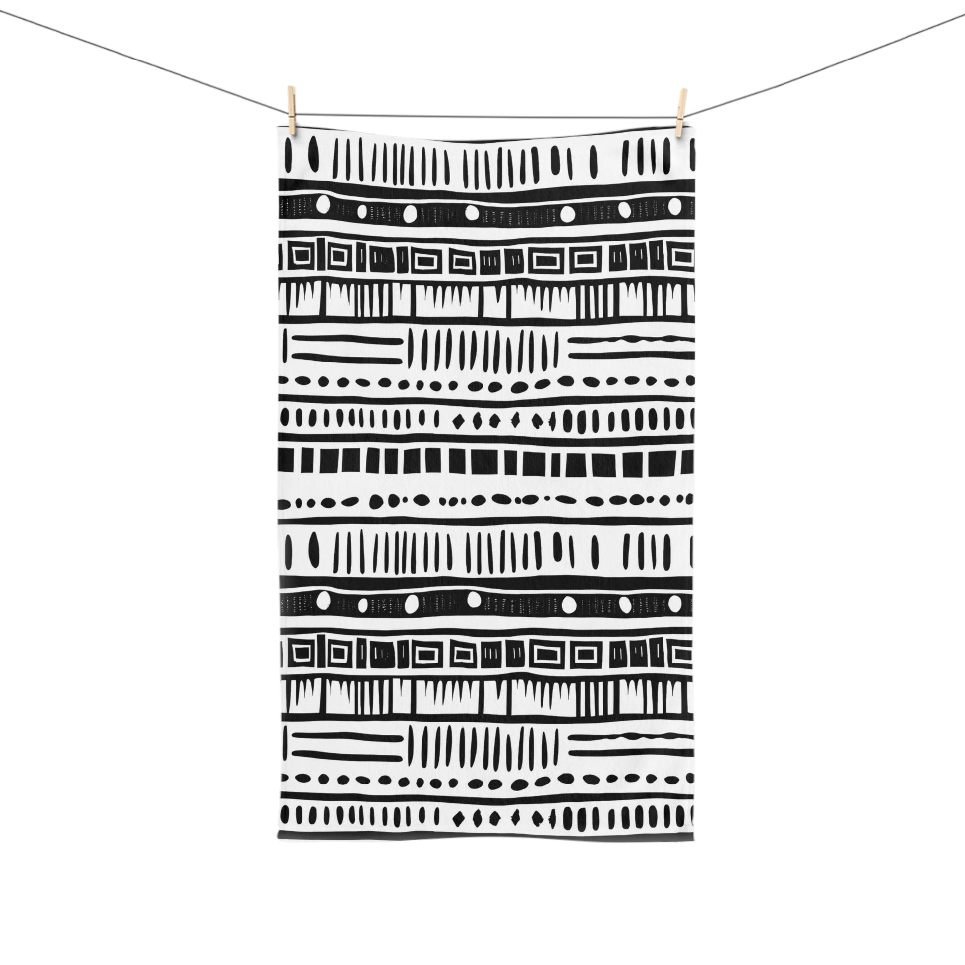Black and white patterned towel hanging on a line