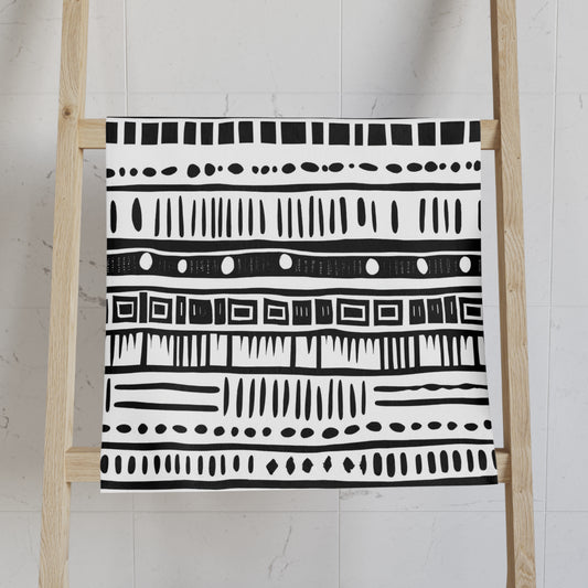 Black and white patterned towel on a wooden ladder against a light background