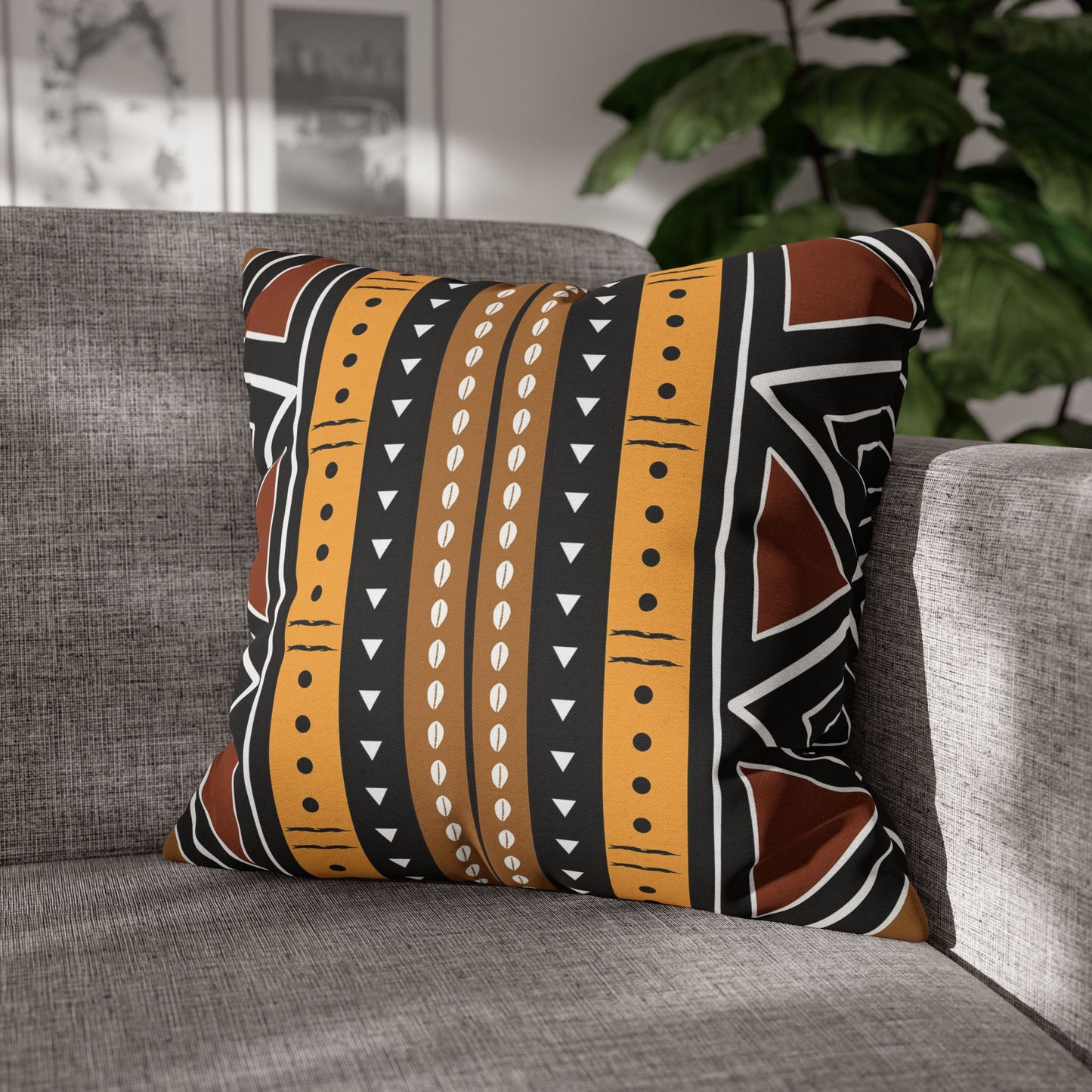 Decorative pillow with tribal pattern on a gray sofa