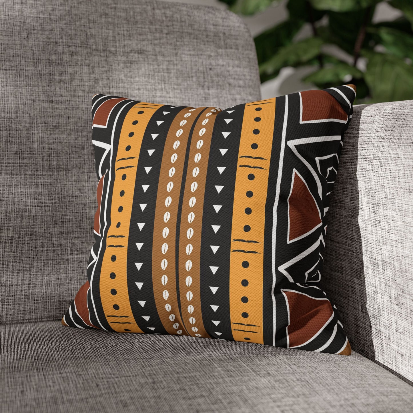 Decorative pillow with tribal pattern on a gray couch