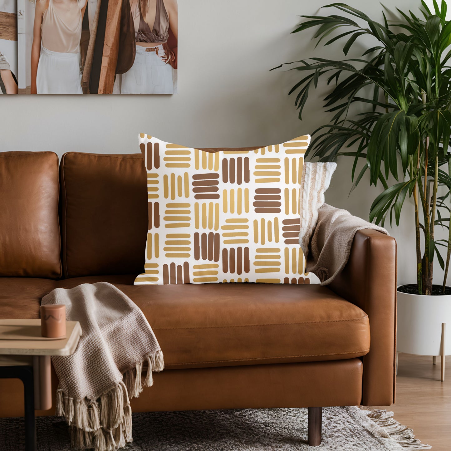 Brown leather sofa with a patterned pillow in a living room setting.