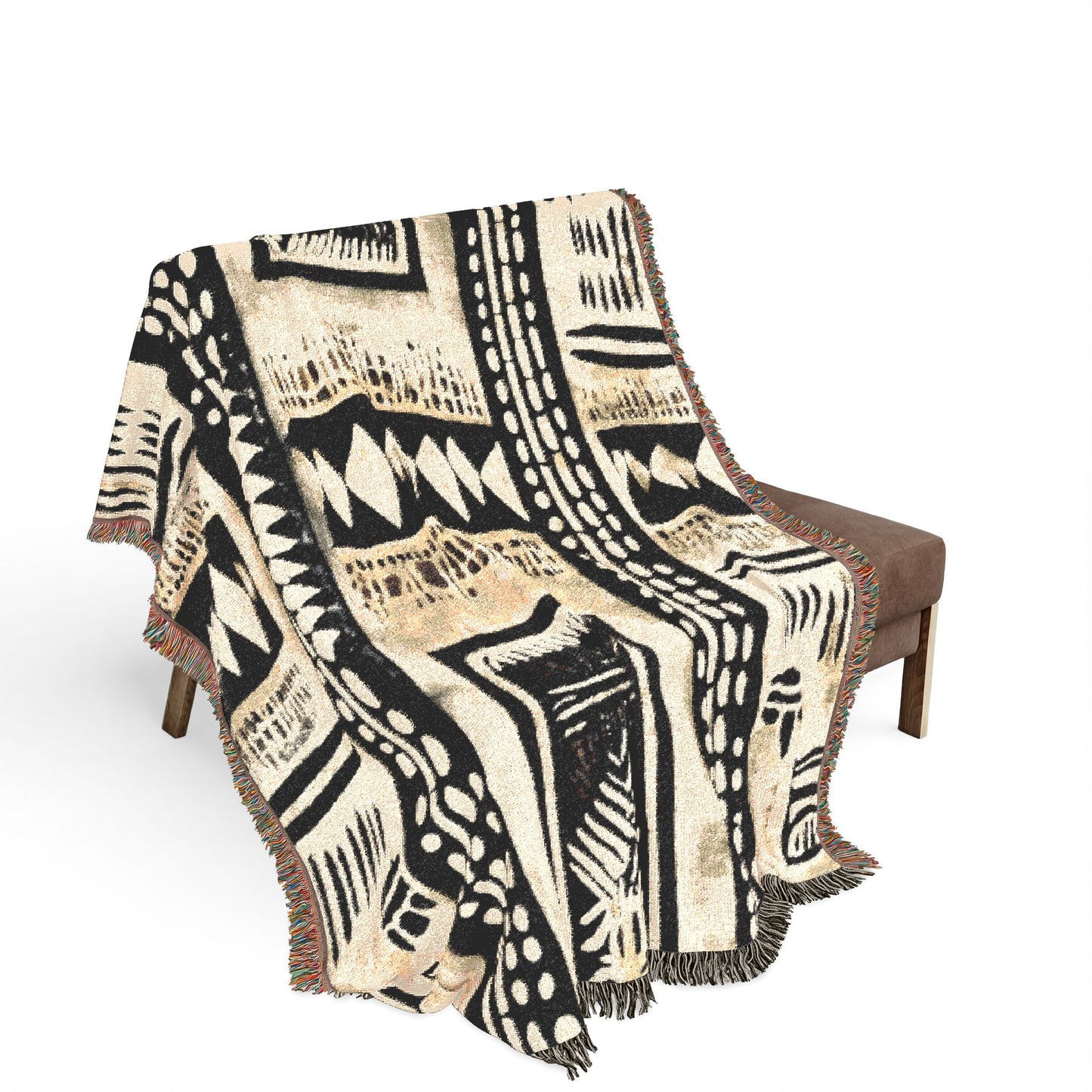 Mudcloth Patterned throw blanket draped over a chair on a white background