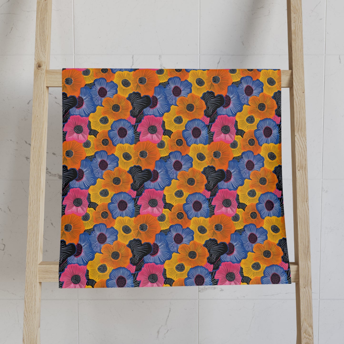 Colorful floral patterned decorative hand towel on a wooden ladder against a white wall.