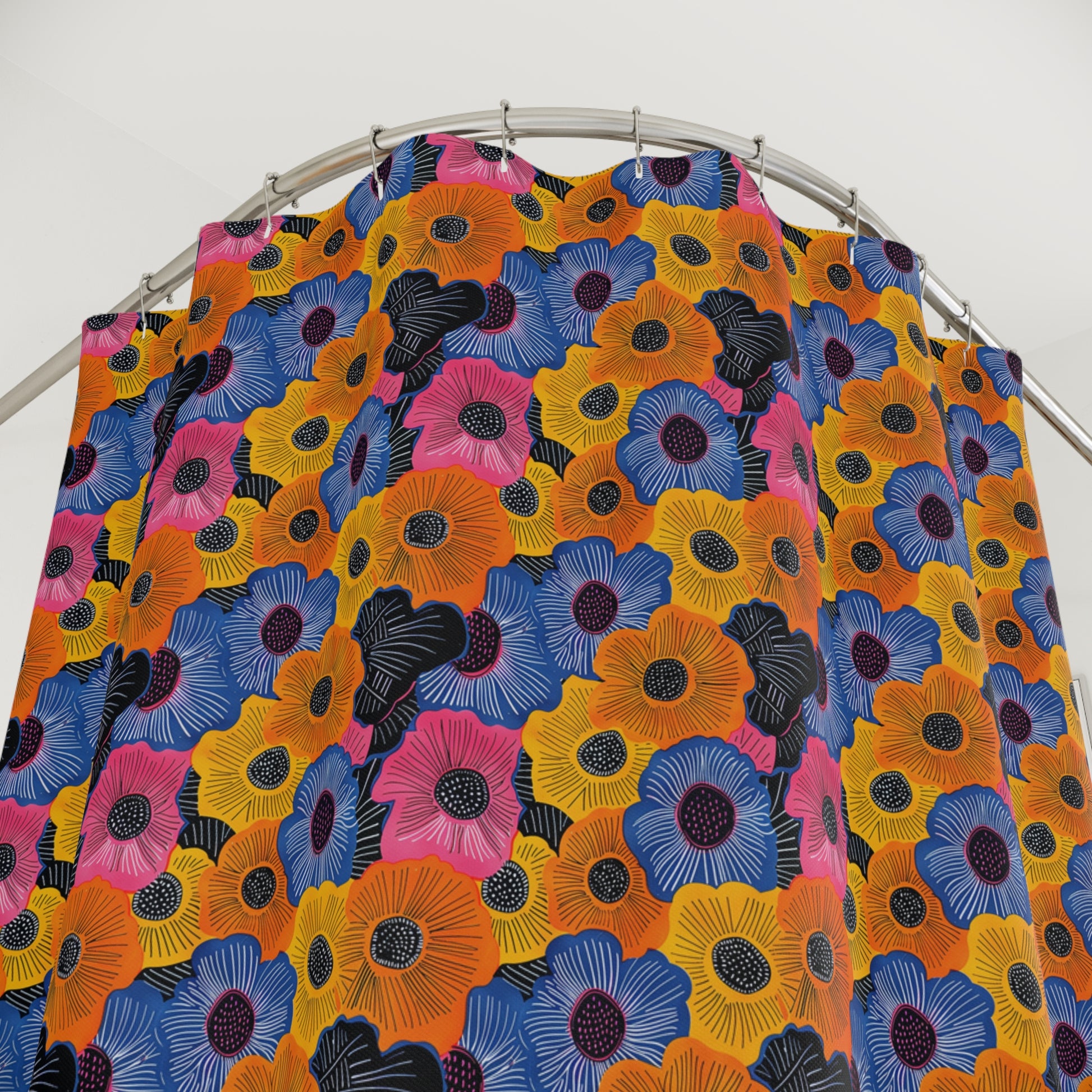 Colorful floral patterned fabric on a metal rod against a white background