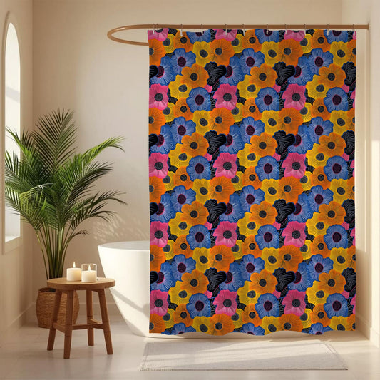 Colorful floral-patterned shower curtain in a bathroom setting with a plant and candles.