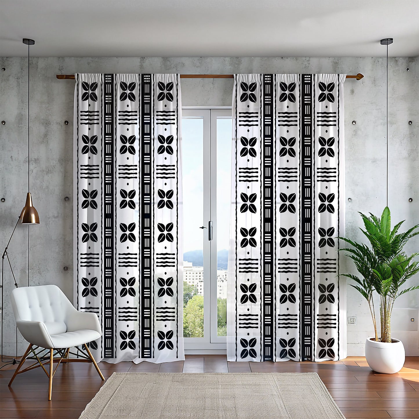 A pair of mudcloth-inspired blackout curtains featuring traditional Bogolan patterns and African shell motifs, hanging in a room with a chair and a plant.