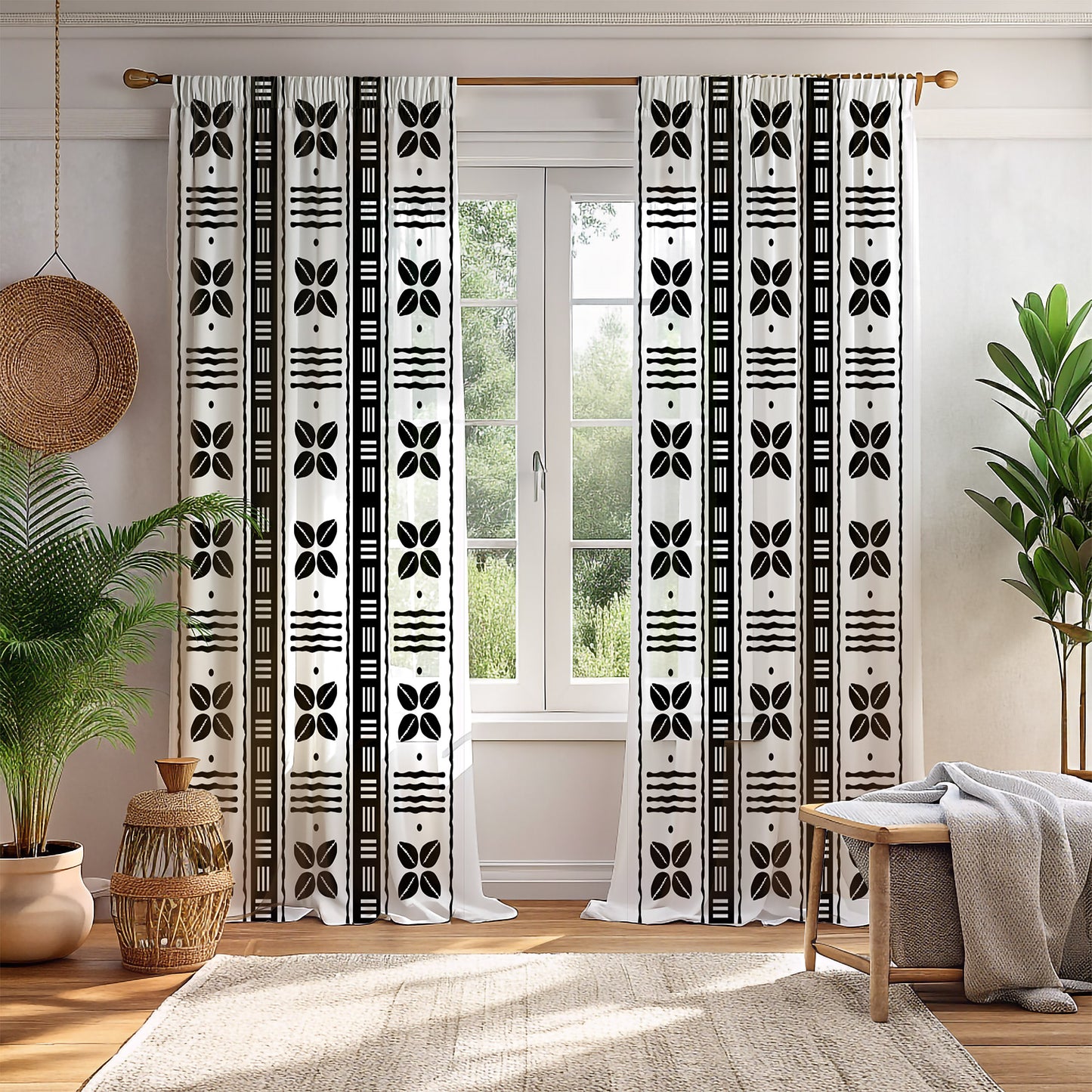 A pair of mudcloth-inspired blackout curtains featuring traditional Bogolan patterns and African shell motifs, hanging in a room with a chair and a plant.